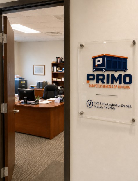 Open office door with the address sign beside it and the front desk visible inside